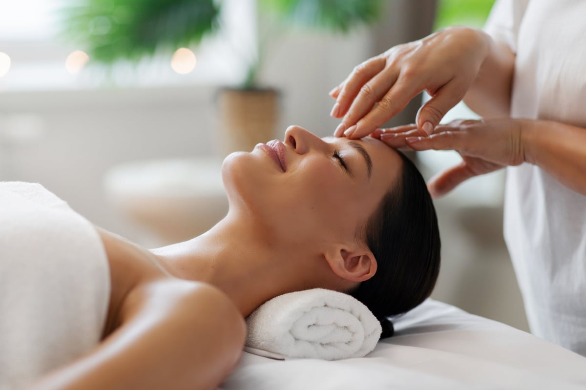 Mujer recibiendo masaje facial relajante en un centro de bienestar